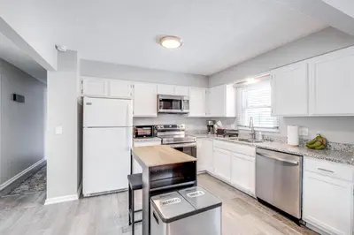 a kitchen with white cabinets and a white refrigerator at 3 Mi to Cuyahoga Valley NP Fairlawn Family Home! in Fairlawn