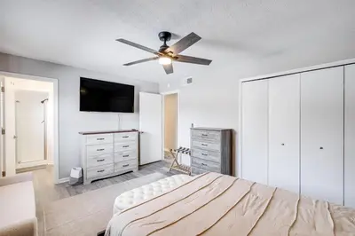 a bedroom with a bed and a ceiling fan at 3 Mi to Cuyahoga Valley NP Fairlawn Family Home! in Fairlawn