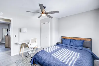 a bedroom with a bed and a ceiling fan at 3 Mi to Cuyahoga Valley NP Fairlawn Family Home! in Fairlawn