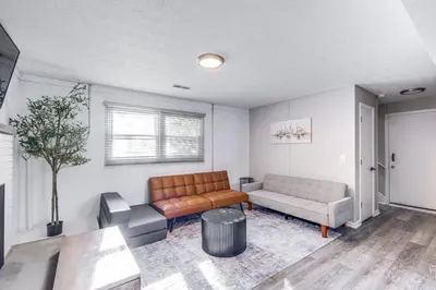 a living room with a couch and a table at 3 Mi to Cuyahoga Valley NP Fairlawn Family Home! in Fairlawn