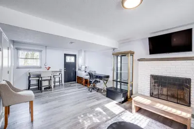 a living room with a fireplace and a dining room at 3 Mi to Cuyahoga Valley NP Fairlawn Family Home! in Fairlawn