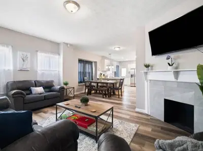 a living room with a couch and a table at Large Remodeled 4 Bedroom Only 7 Minutes to Downtown in Cleveland