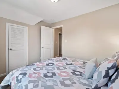 a bedroom with a bed with a colorful quilt at Large Remodeled 4 Bedroom Only 7 Minutes to Downtown in Cleveland