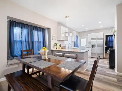 a kitchen and dining room with a wooden table and chairs at Large Remodeled 4 Bedroom Only 7 Minutes to Downtown in Cleveland