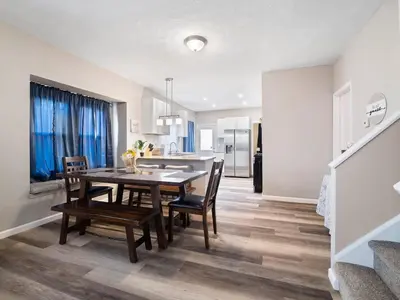 a kitchen and dining room with a table and chairs at Large Remodeled 4 Bedroom Only 7 Minutes to Downtown in Cleveland