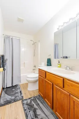 a white bathroom with a sink and a toilet at Comfort Awaits at Cozy Get Away - Dog Friendly in Akron