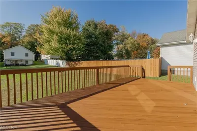 a wooden walkway in a yard with a fence at Comfort Awaits at Cozy Get Away - Dog Friendly in Akron