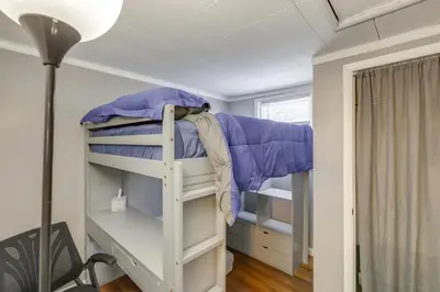 a bunk bed in a room with a lamp at 3 Mi to Englewood Dam Pet-Friendly Home with Yard! in Englewood