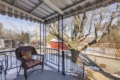 a porch with a chair and a tree at 3 Mi to Englewood Dam Pet-Friendly Home with Yard! in Englewood