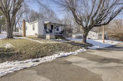 a white house with two trees in the snow at 3 Mi to Englewood Dam Pet-Friendly Home with Yard! in Englewood