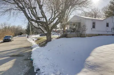 a house with snow on the side of a street at 3 Mi to Englewood Dam Pet-Friendly Home with Yard! in Englewood