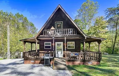 a log home with a large porch and balcony at The Best of Cave Run & Morehead! in Morehead