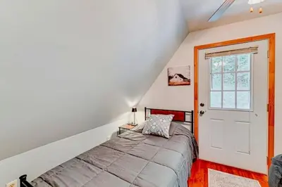 a bedroom with a bed and a white door at The Best of Cave Run & Morehead! in Morehead