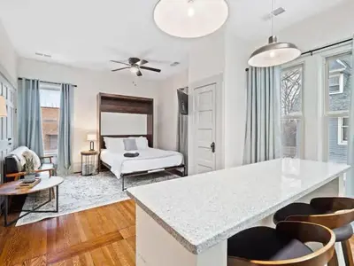 a kitchen and living room with a bed in the background at Victorian Estates - Cute Stuido - Steps To Clinic in Cleveland