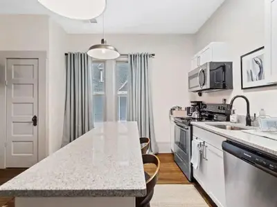 a kitchen with a sink and a counter top at Victorian Estates - Cute Stuido - Steps To Clinic in Cleveland