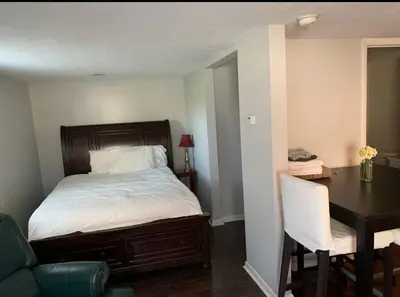 a bedroom with a bed and a desk and a table at Country Getaway in Stewart