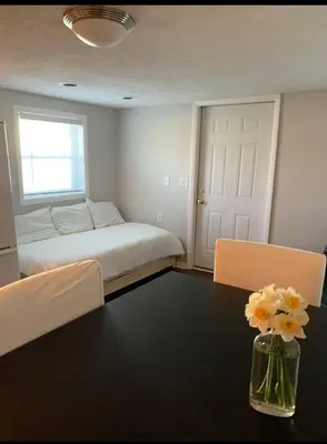 a bedroom with a bed and a table with flowers at Country Getaway in Stewart