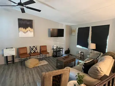 a living room with a couch and a tv at Modern Glass City Home in Toledo