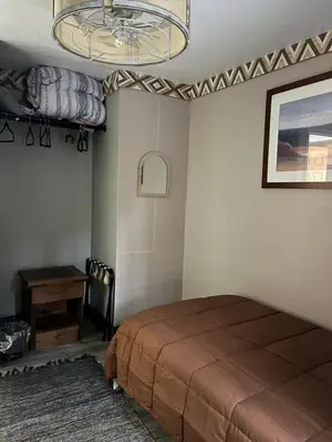 a bedroom with a bed and a table and a chandelier at Modern Glass City Home in Toledo