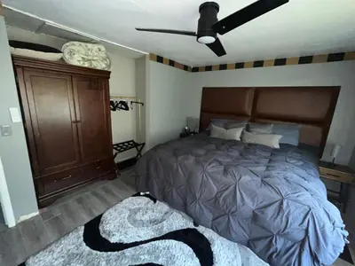 a bedroom with a bed and a ceiling fan at Modern Glass City Home in Toledo