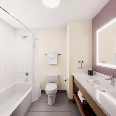 a bathroom with a toilet and a tub and a sink at Holiday Inn Express & Suites Muncie Northwest by IHG in Muncie