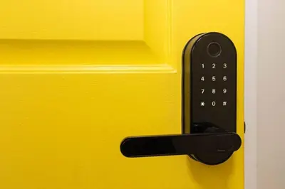 a remote control on the side of a yellow door at Yellow Harmony in South Euclid