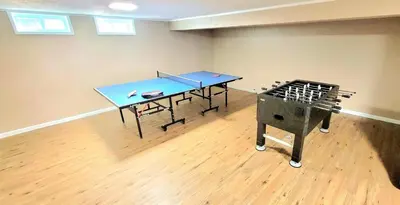 a ping pong table in an empty room with a ping pong table at Yellow Harmony in South Euclid