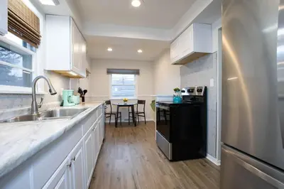a kitchen with a sink and a dishwasher at Yellow Harmony in South Euclid