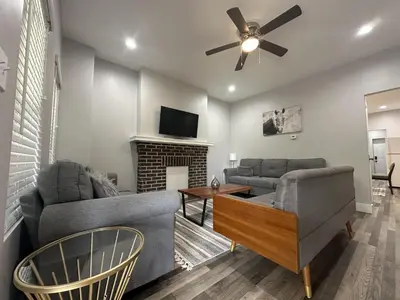 a living room with two couches and a fireplace at Cityscape 2BR Near Downtown in Columbus