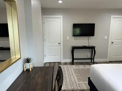 a bedroom with a bed and a television and a table at Cityscape 2BR Near Downtown in Columbus