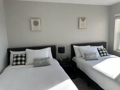 two beds sitting next to each other in a bedroom at Cityscape 2BR Near Downtown in Columbus