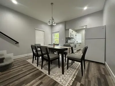 a kitchen and dining room with a table and chairs at Cityscape 2BR Near Downtown in Columbus