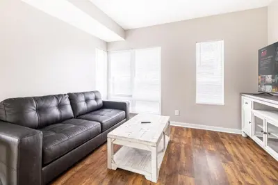 a living room with a leather couch and a coffee table at Luxury Downtown Townhome Private Garage Unit 3 in Cleveland