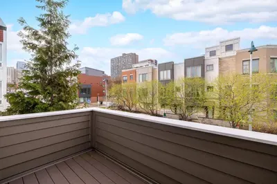 a balcony with trees and buildings in the background at Luxury Downtown Townhome Private Garage Unit 3 in Cleveland