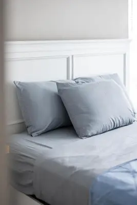 a bed with two pillows on top of it at Luxury Downtown Townhome Private Garage Unit 3 in Cleveland