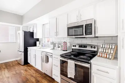 a kitchen with white cabinets and a stove top oven at Luxury Downtown Townhome Private Garage Unit 4 in Cleveland
