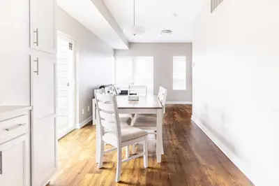 a white dining room with a white table and chairs at Luxury Downtown Townhome Private Garage Unit 4 in Cleveland