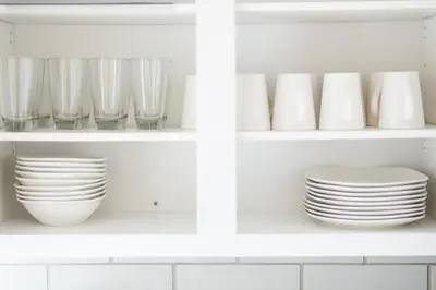 a white kitchen shelf with plates and bowls at Luxury Downtown Townhome Private Garage Unit 4 in Cleveland