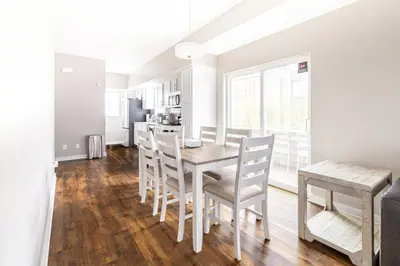 a kitchen and dining room with a wooden table and chairs at Luxury Downtown Townhome Private Garage Unit 10 in Cleveland