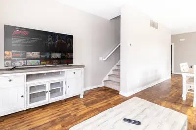a living room with a large flat screen tv at Luxury Downtown Townhome Private Garage Unit 10 in Cleveland