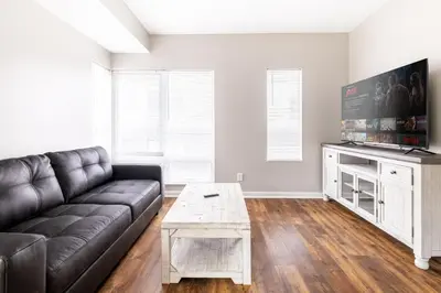 a living room with a couch and a tv at Luxury Downtown Townhome Private Garage Unit 10 in Cleveland