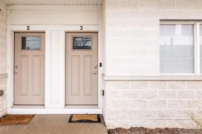 a pair of doors on a white house at Luxury Downtown Townhome Private Garage Unit 11 in Cleveland