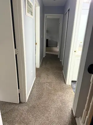 a hallway with white walls and carpet at Private Cul-de-Sac Oasis 4BR in Grove City