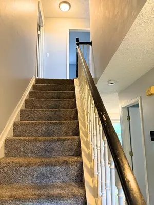 a staircase in a home with a stair railing at Private Cul-de-Sac Oasis 4BR in Grove City