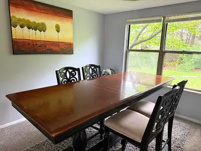 a dining room with a wooden table and chairs at Private Cul-de-Sac Oasis 4BR in Grove City