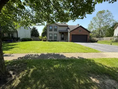 a house with a large yard with a driveway at Private Cul-de-Sac Oasis 4BR in Grove City