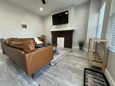 a living room with a couch and a fireplace at Urban Retreat 2BR Near Downtown in Columbus