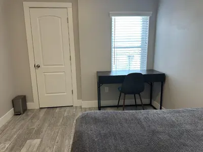a bedroom with a desk and a chair next to a window at Urban Retreat 2BR Near Downtown in Columbus