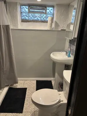 a bathroom with a toilet and a sink at Private tiny room for one in Cincinnati