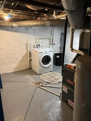a laundry room with a washing machine in a building at Private tiny room for one in Cincinnati